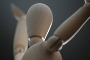 Image shows a wooden artist's mannequin. 